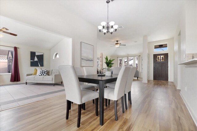 dining room with visible vents, light wood-style flooring, and ceiling fan with notable chandelier