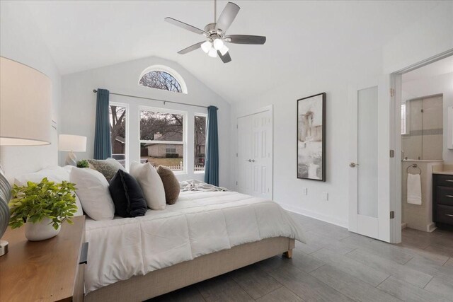 bedroom featuring lofted ceiling, wood finished floors, baseboards, and ceiling fan