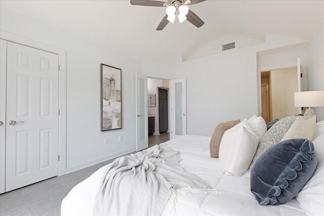 bedroom with visible vents, a ceiling fan, connected bathroom, baseboards, and vaulted ceiling