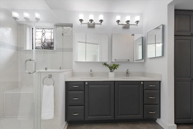 full bath featuring a sink, double vanity, and a shower stall