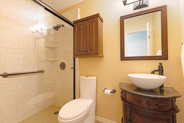 full bath with vanity, a shower stall, and toilet