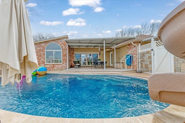 pool with a patio area and ceiling fan