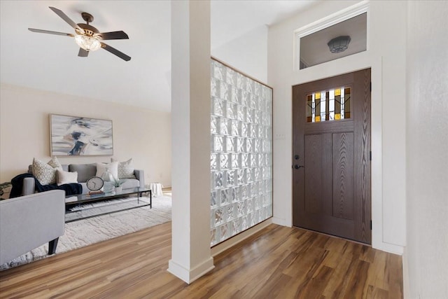 foyer with ceiling fan and wood finished floors