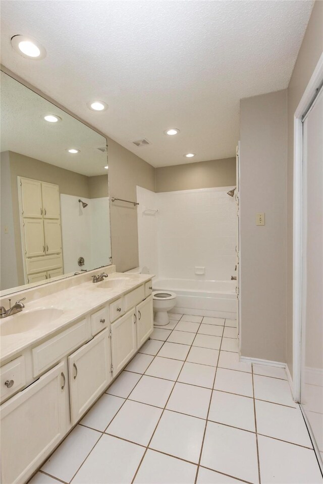 bathroom with visible vents, double vanity, recessed lighting, tile patterned floors, and a sink