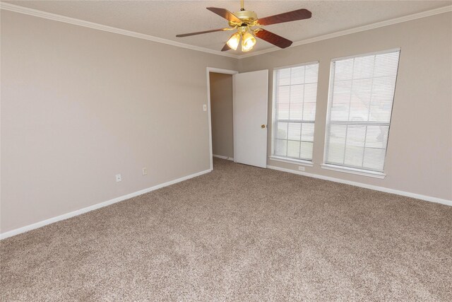 empty room with a textured ceiling, ceiling fan, carpet, and ornamental molding