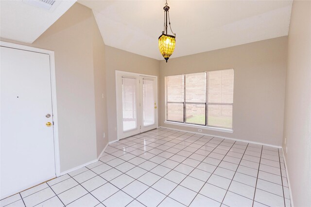 unfurnished room with light tile patterned flooring, visible vents, and baseboards