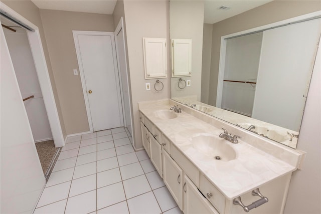 full bath with double vanity, visible vents, tile patterned floors, and a sink