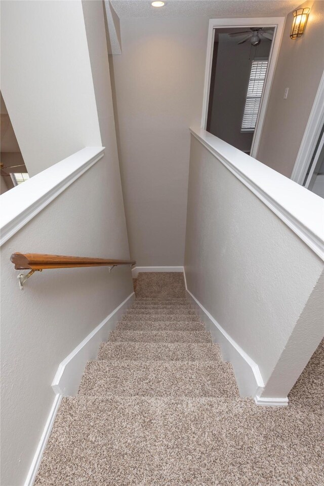 stairway with carpet and baseboards