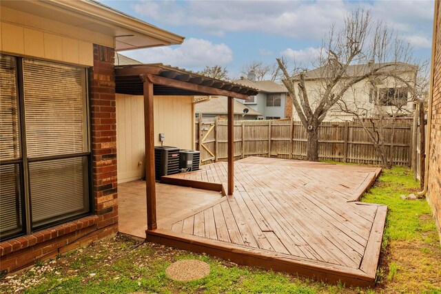 wooden terrace featuring a fenced backyard and central AC