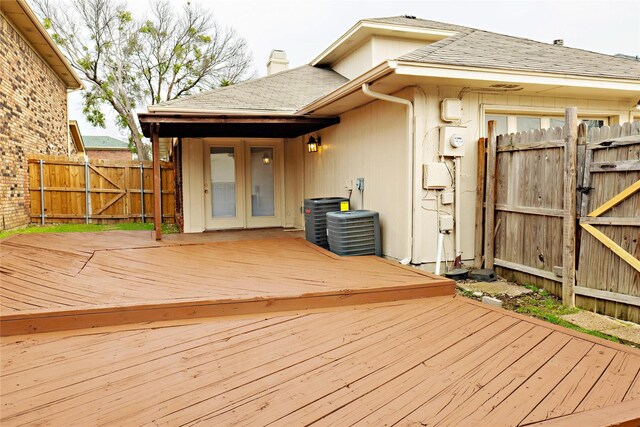 deck with central air condition unit, a gate, french doors, and fence