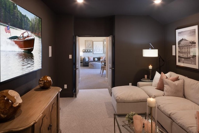 living area with lofted ceiling and light colored carpet