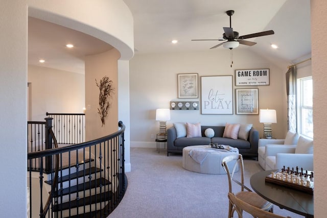 carpeted living area featuring arched walkways, recessed lighting, and baseboards