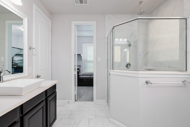 bathroom featuring vanity, visible vents, baseboards, a shower stall, and marble finish floor