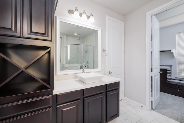 bathroom with a shower stall, vanity, and marble finish floor