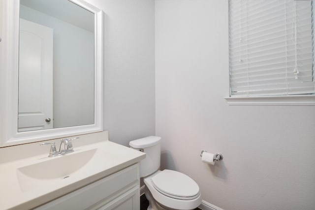 bathroom featuring toilet and vanity