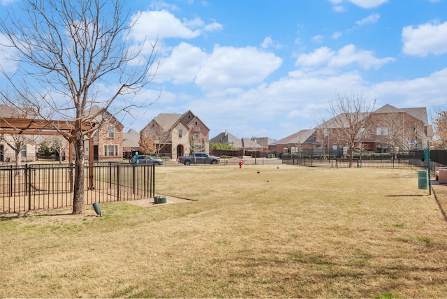 view of yard featuring fence and a residential view