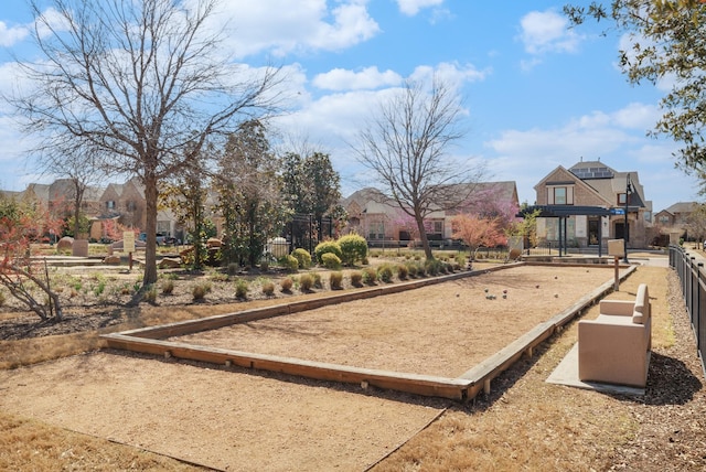 view of property's community with fence and a residential view