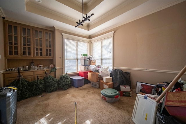 dining space featuring a tray ceiling, crown molding, and carpet