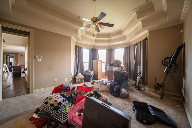 bedroom featuring a raised ceiling, crown molding, carpet, and baseboards