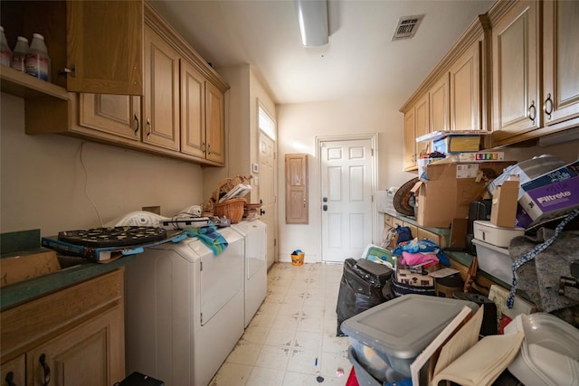 clothes washing area featuring washer and dryer, cabinet space, visible vents, and light floors