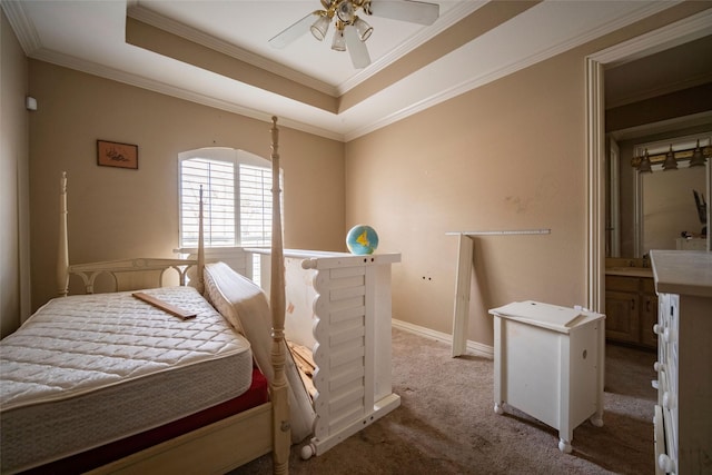 bedroom featuring a raised ceiling, crown molding, and carpet