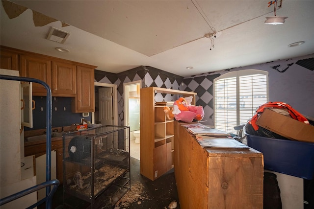 kitchen featuring visible vents and wallpapered walls