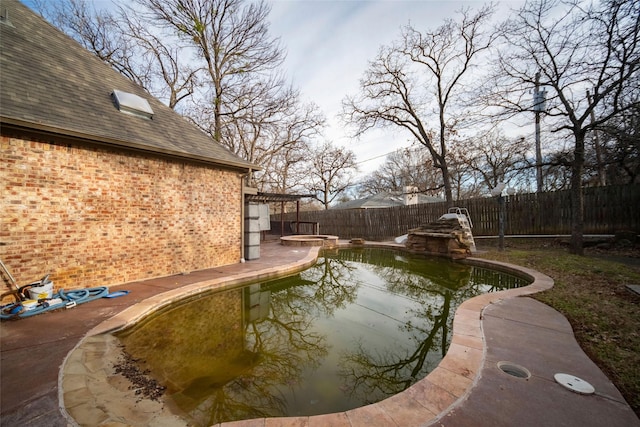 view of swimming pool featuring an in ground hot tub, a fenced backyard, a fenced in pool, and a patio