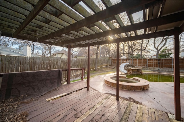 deck with a fenced backyard and a pergola