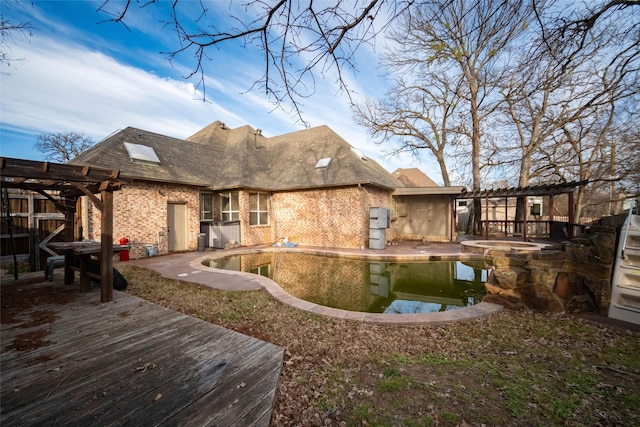 rear view of house featuring an outdoor pool, brick siding, an in ground hot tub, and a pergola