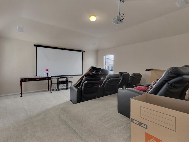 cinema room featuring a garage, lofted ceiling, and carpet flooring