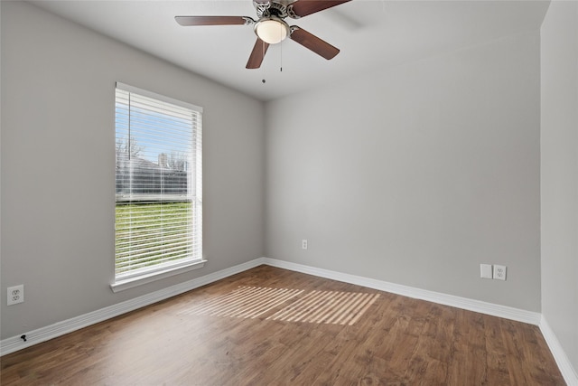 unfurnished room featuring a ceiling fan, baseboards, and wood finished floors