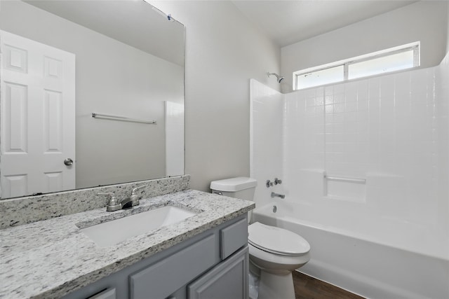 full bath featuring vanity, toilet, wood finished floors, and bathtub / shower combination