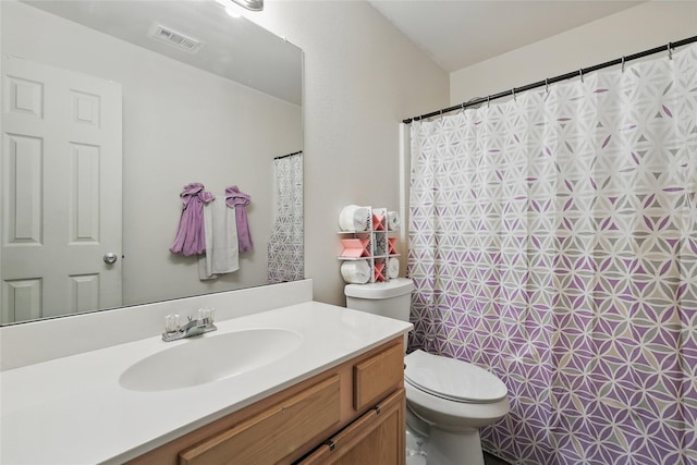 bathroom featuring vanity, a shower with shower curtain, toilet, and visible vents