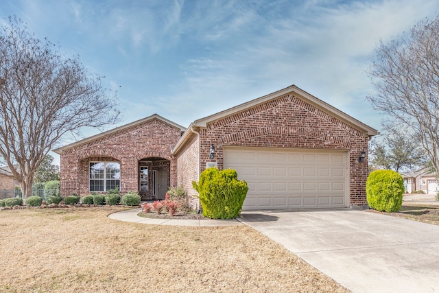 ranch-style home featuring brick siding, driveway, and an attached garage