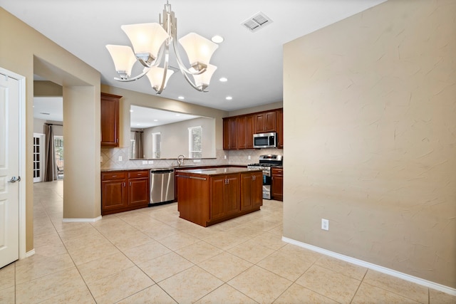 kitchen featuring light tile patterned floors, visible vents, stainless steel appliances, decorative backsplash, and a center island