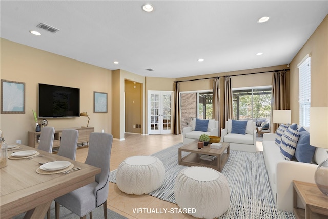 living room featuring light tile patterned floors, visible vents, recessed lighting, and french doors