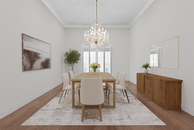 dining area with wood finished floors, baseboards, and ornamental molding