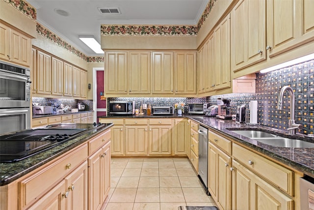 kitchen featuring visible vents, ornamental molding, a sink, appliances with stainless steel finishes, and light tile patterned flooring