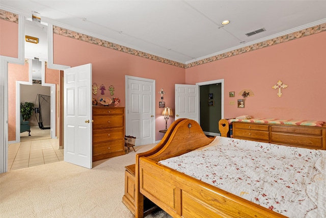 bedroom with light tile patterned floors, visible vents, light colored carpet, and ornamental molding