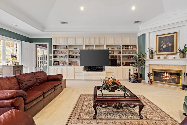 living area with visible vents, lofted ceiling, ornamental molding, and a tile fireplace