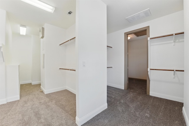 walk in closet featuring attic access, carpet, and visible vents