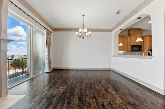 interior space with dark wood finished floors, crown molding, baseboards, and visible vents