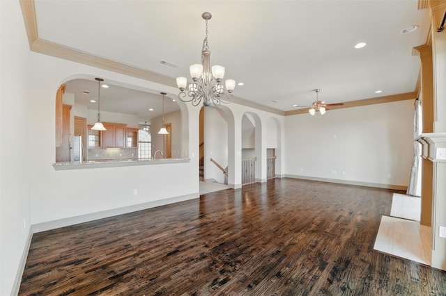 unfurnished living room with dark wood finished floors, baseboards, visible vents, and ornamental molding