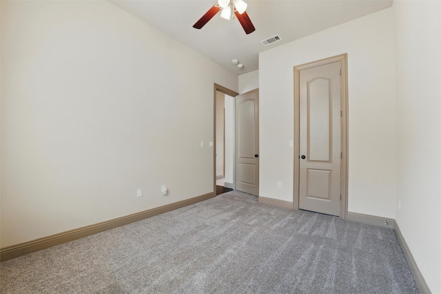 unfurnished bedroom featuring visible vents, carpet flooring, baseboards, and ceiling fan