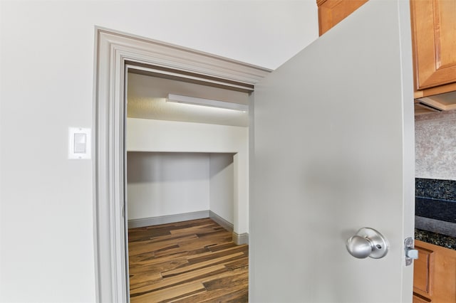 room details with baseboards and wood finished floors