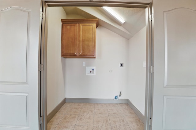 clothes washing area featuring electric dryer hookup, washer hookup, hookup for a gas dryer, cabinet space, and light tile patterned floors