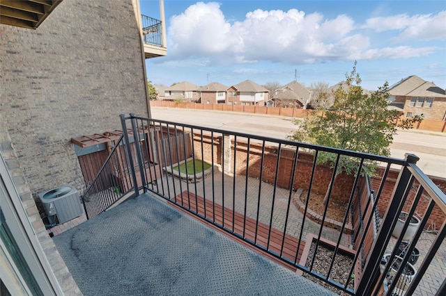 balcony with a residential view and cooling unit