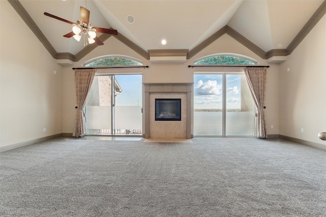 unfurnished living room featuring high vaulted ceiling, plenty of natural light, carpet, and a fireplace