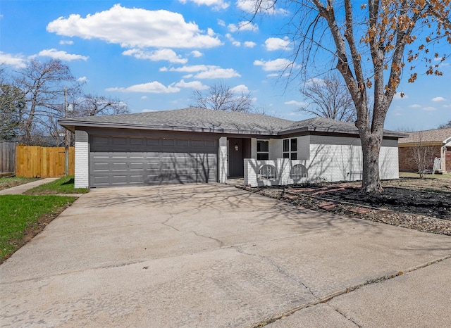 ranch-style house featuring brick siding, an attached garage, driveway, and fence