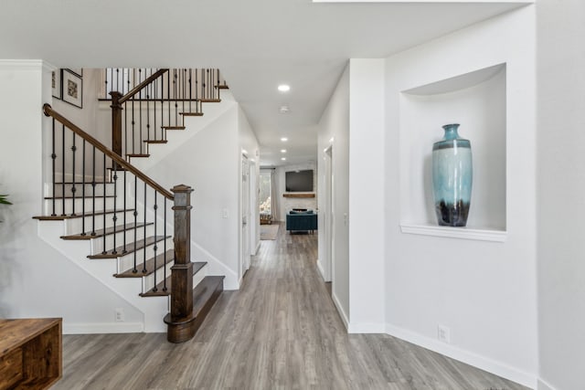 entryway with stairway, recessed lighting, wood finished floors, and baseboards